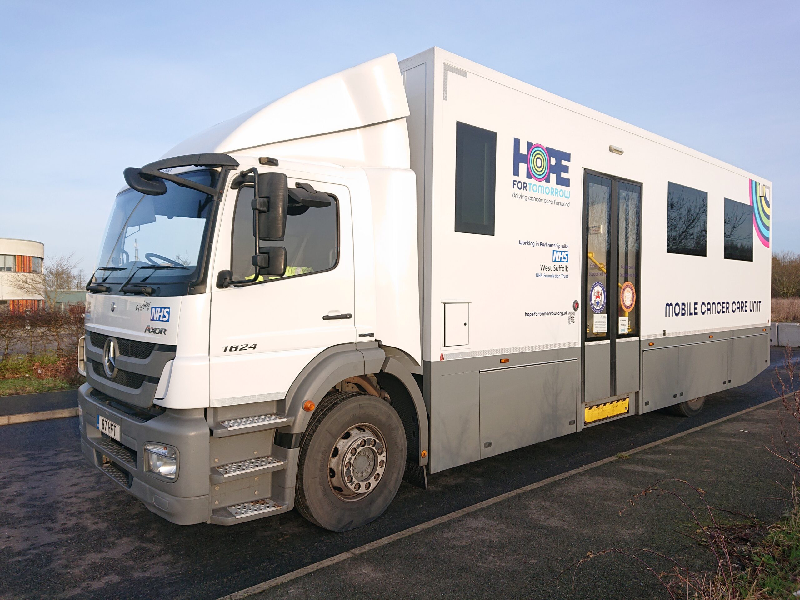 An image showing the front and side of Hope for Tomorrow's West-Suffolk-based mobile cancer care unit, Frisbey..