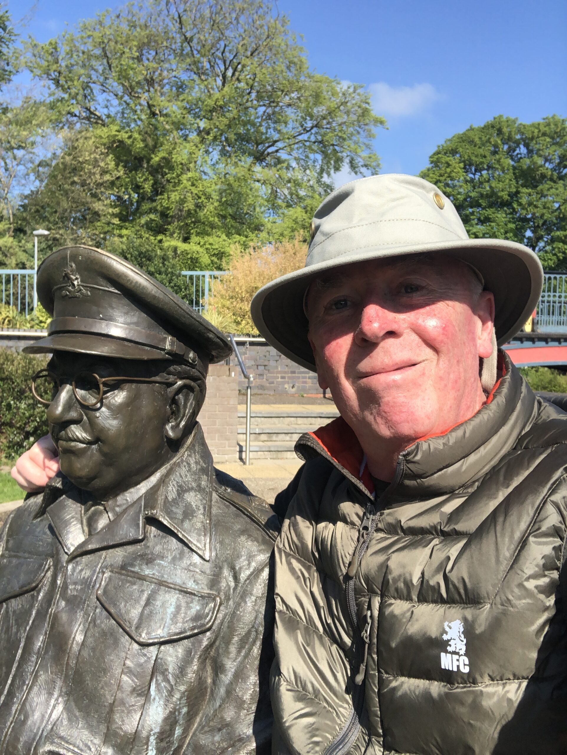 Stan Jackson A photo of Stan Jackson on the right, standing and smiling next to a bronze statue of another gentleman.
