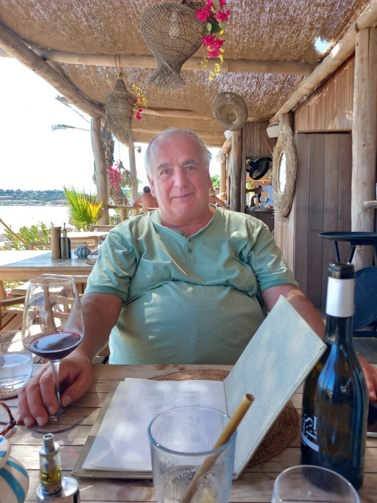 An image of Mick McLean smiling on holiday