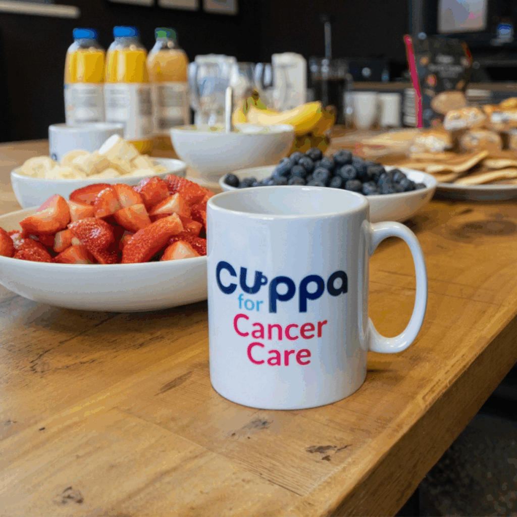 Cuppa for Cancer Care table laid out with mugs and sweet treats