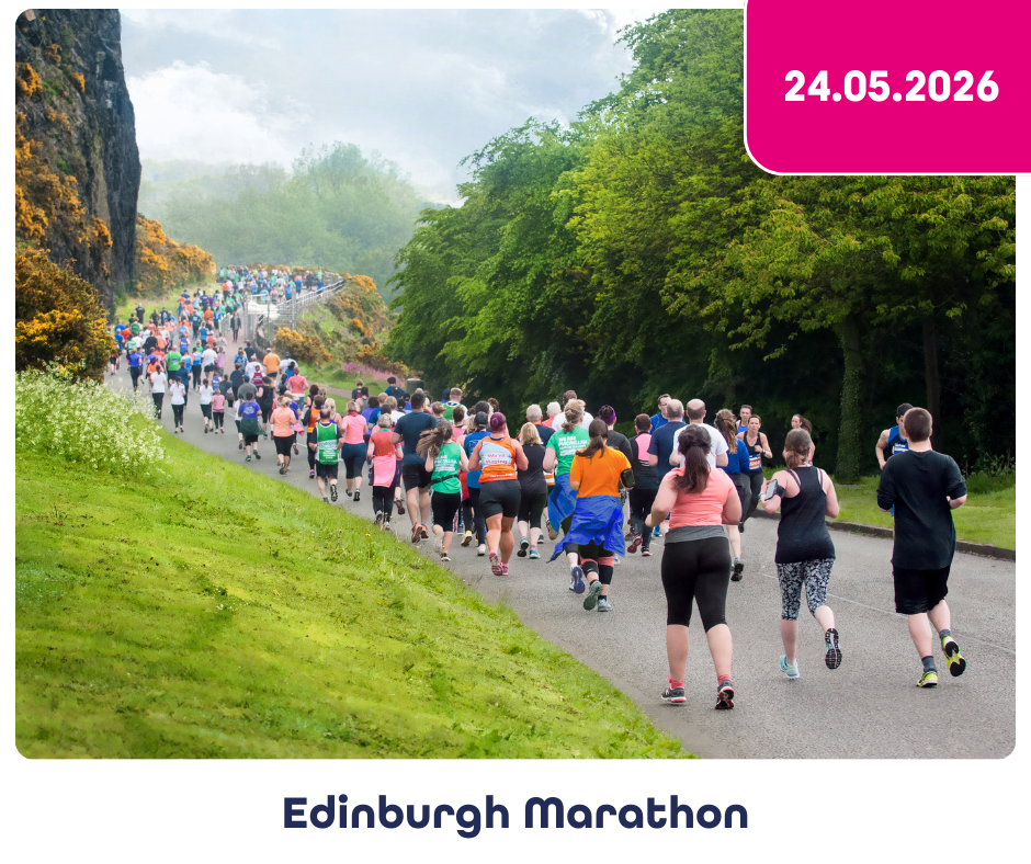 Runners moving up a hill as part of the Edinburgh Marathon 