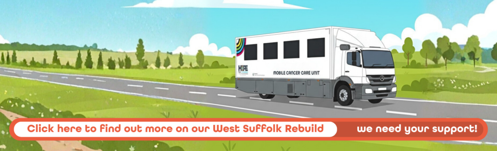 Dora sat outside at a restaurant, looking towards the camer and smiling.