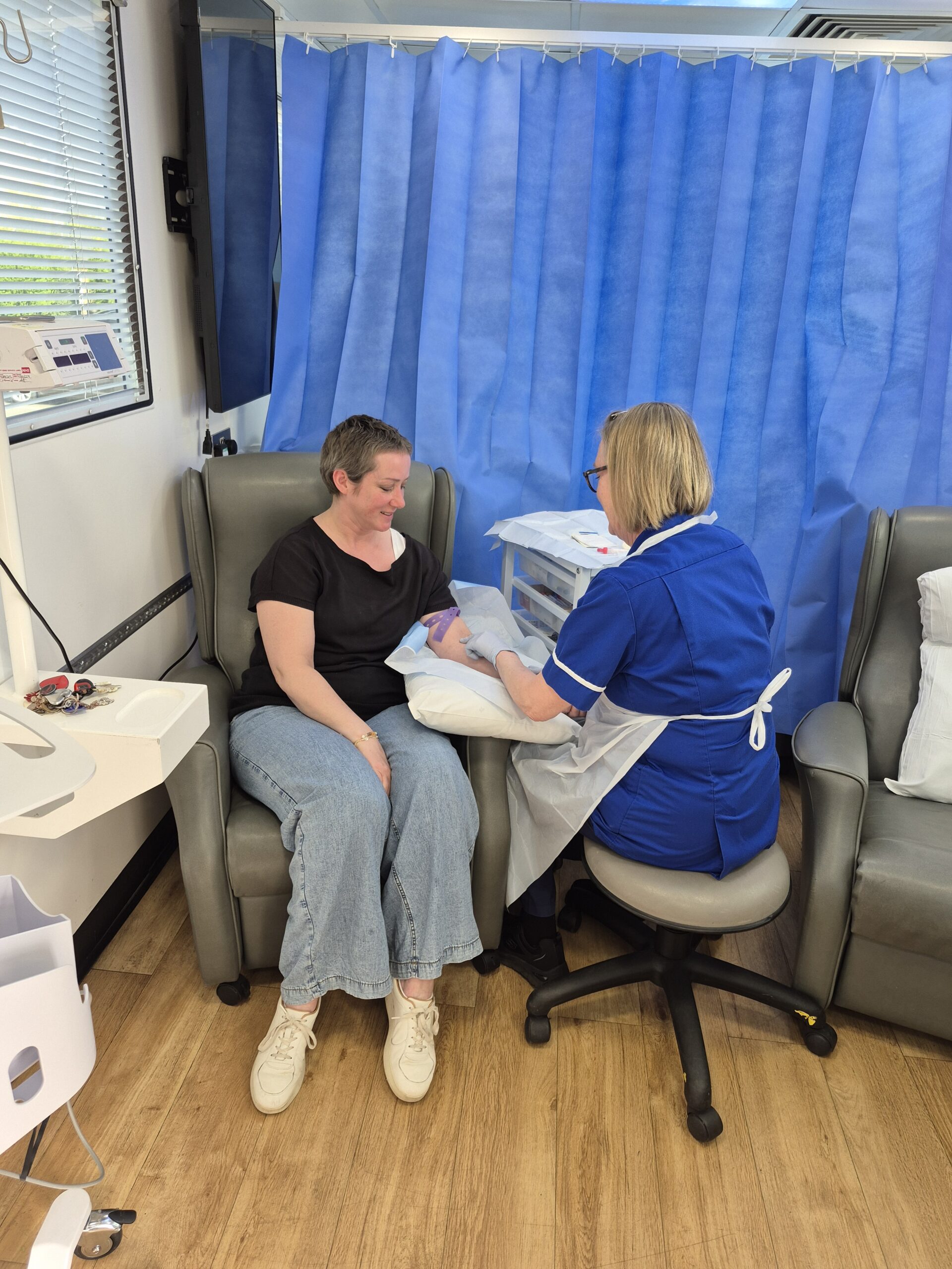 An image showing the side of the Hope for Tomorrow mobile cancer care unit 'Elaine' - the doors are open and the steps are down, ready to welcome patients on board for their treatment