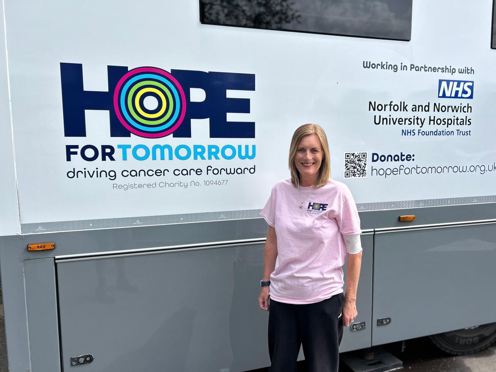 An image showing a gentleman, Paul, having treatment on board a mobile cancer care unit, sitting in a grey chemotherapy chair