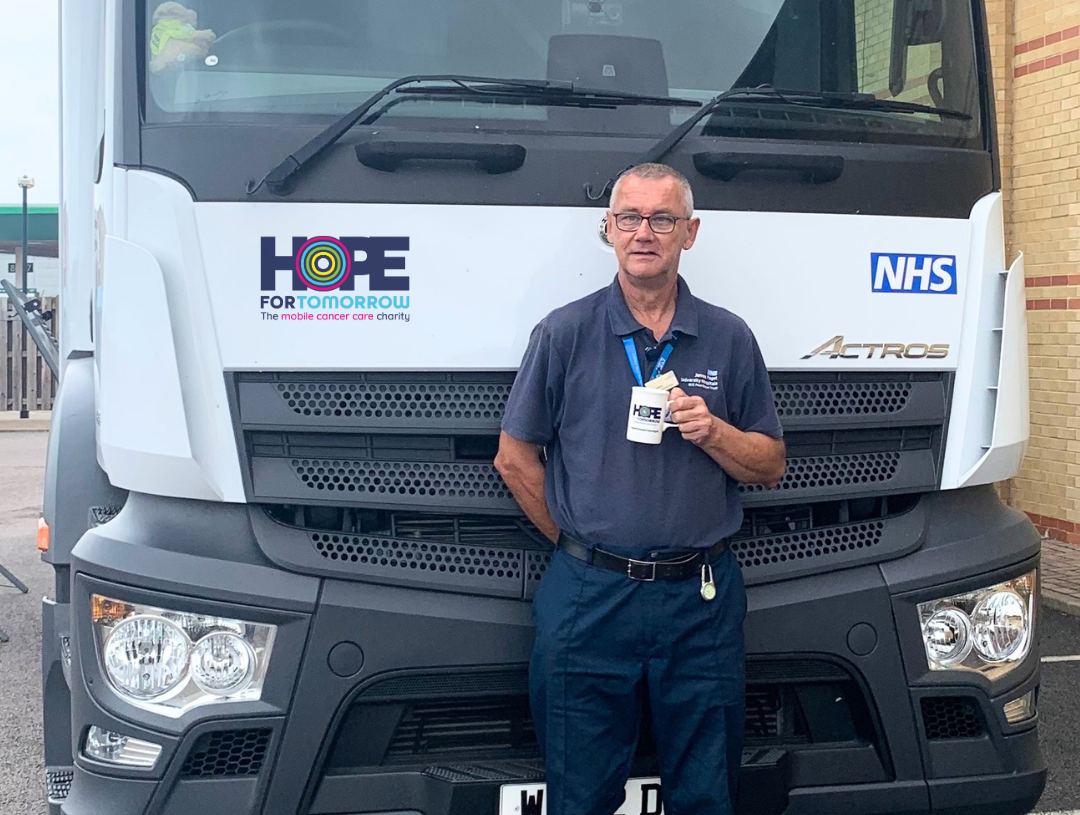 Mobile unit driver, Mark, in front of the mobile cancer care unit